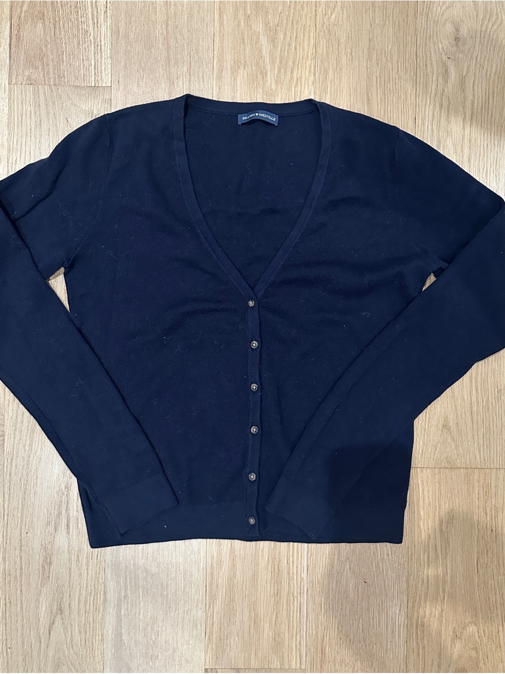 Brandy Melville navy cardigan 
Measures 21.5” long, never worn